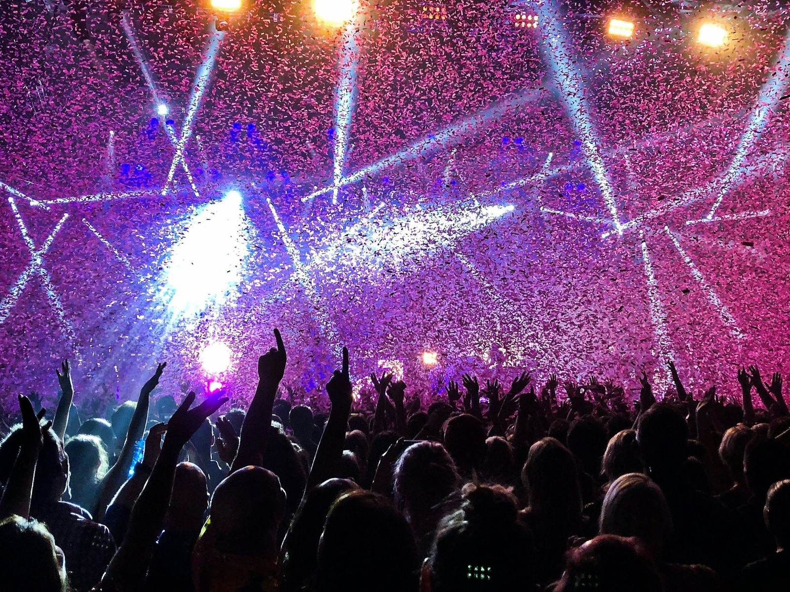 Audience under stage lasers at a live event