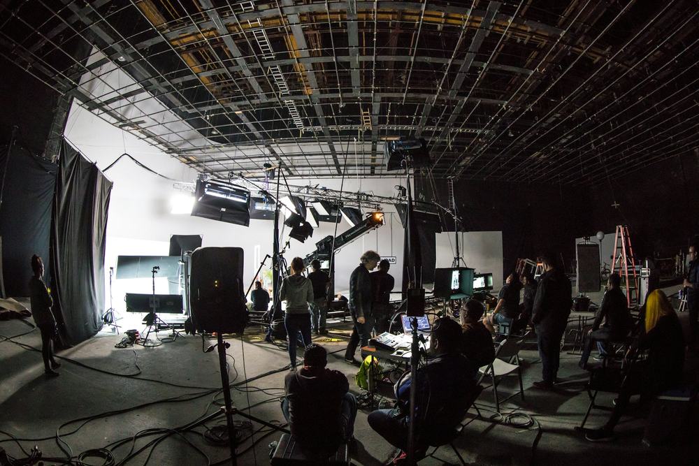 Crew working on a lit soundstage